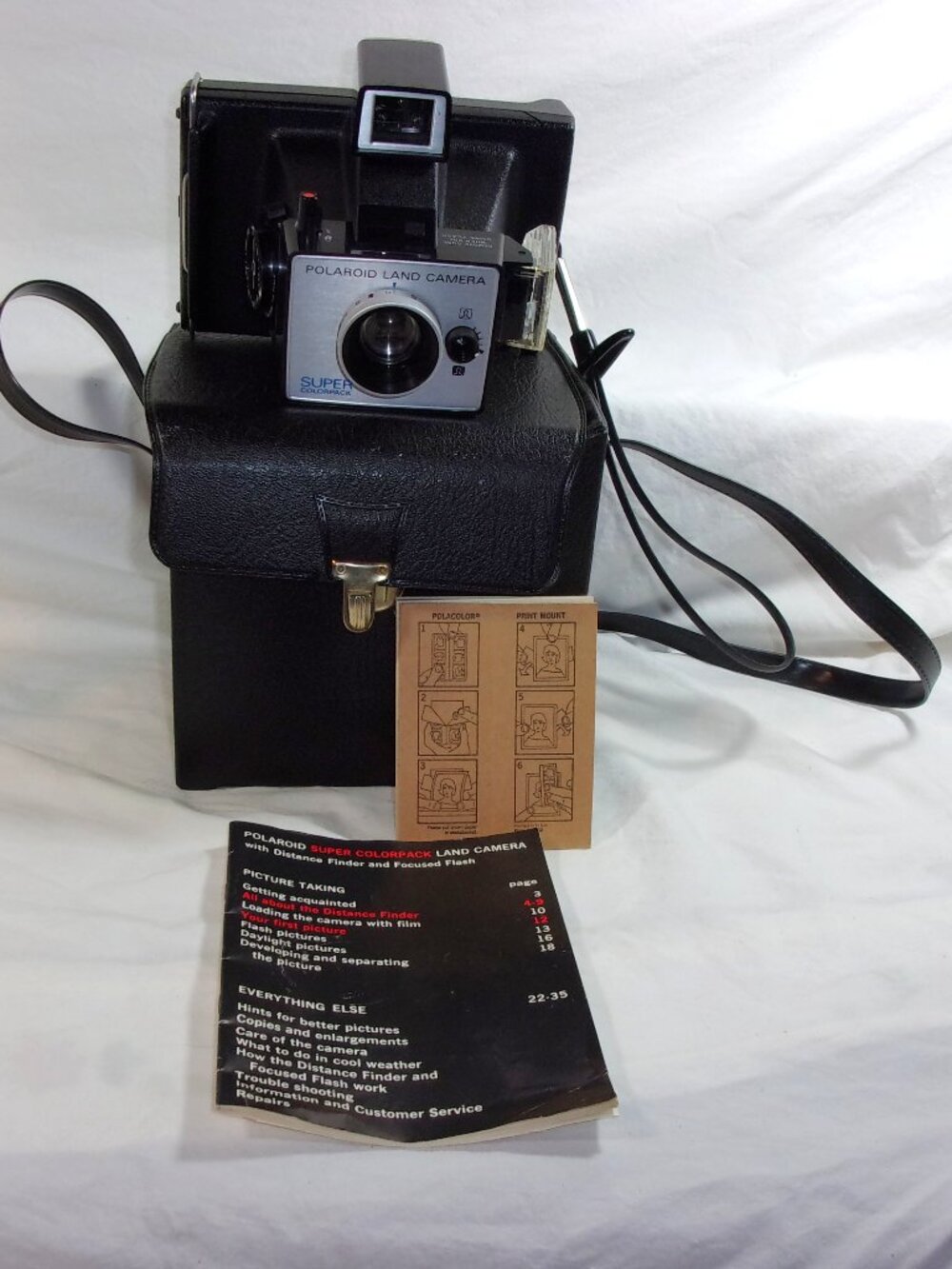 VINTAGE POLAROID SUPER COLORPACK LAND CAMERA WITH INSTRUCTIONS AND CARRYING CASE